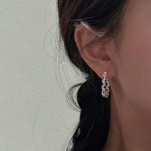 Minimalist S925 sterling silver hoop earrings with a twisted wave texture on model