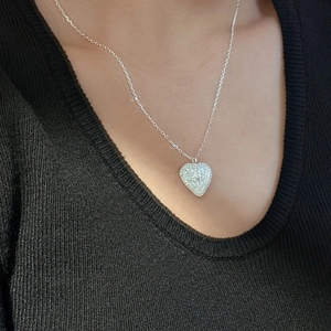 Vintage S925 sterling silver heart necklace with zircon on black knitwear model