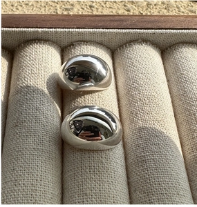 Macro detail of chunky S925 sterling silver dome rings with high polished mirror finish