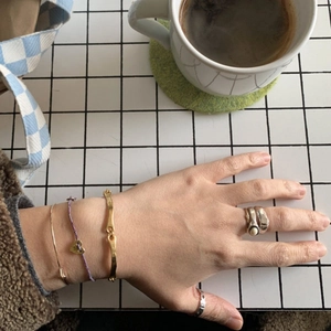 S925 sterling silver square ring and mixed bracelets styled in a trendy cafe setting
