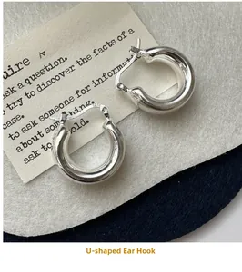 Macro shot of S925 sterling silver U-shaped hoop earrings with hallmark engraving