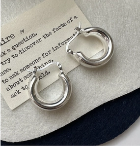 Macro view of chunky S925 sterling silver hoop earrings with high polish finish