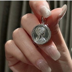 Close-up of S925 sterling silver coin pendant featuring a vintage female relief