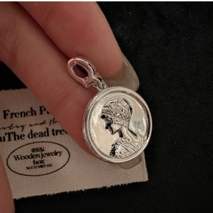 Detailed macro of S925 sterling silver coin pendant with vintage portrait relief