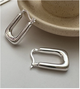 Close-up of S925 sterling silver rectangular hoop earrings with a high-polished finish