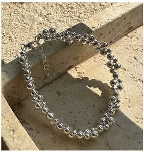 Close-up of S925 sterling silver beaded bracelet with heart charm and lobster clasp