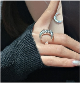 Detailed close-up of knotted moon horn ring in S925 sterling silver on model hand