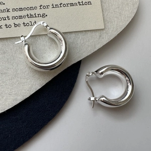 Polished S925 sterling silver hoop earrings with clear hallmark engraving on white base