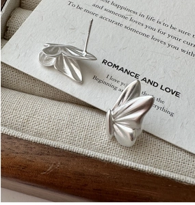 Macro shot of S925 sterling silver stamp on matte butterfly wing stud earrings