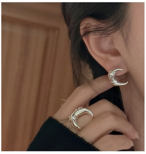 Detail showing polished S925 silver moon earrings and ring with wrapped wire design