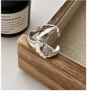 Detail showing S925 sterling silver hallmark and elegant twisted knot design on the ring