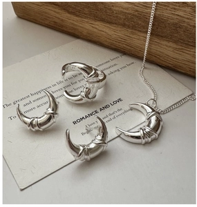 Detail of S925 sterling silver crescent jewelry set featuring knotted texture finish