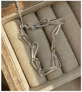 Macro shot of S925 sterling silver geometric link bracelet with adjustable draw chain