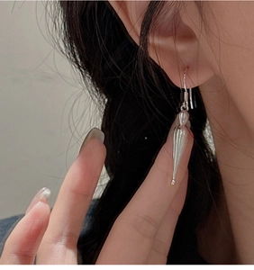 Close-up of teardrop S925 sterling silver earrings with mirror finish on model
