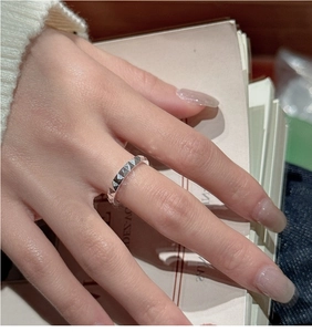 Close-up of S925 sterling silver ring with CNC carved pyramid stud pattern on index finger