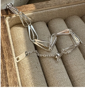 Detail of S925 sterling silver hollow water drop link bracelet with adjustable chain