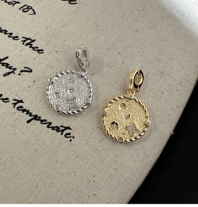 Close-up of S925 sterling silver coin pendants with hammer texture and star detail