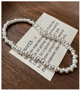 Detailed macro view of S925 sterling silver beaded bracelet with vertical striped texture