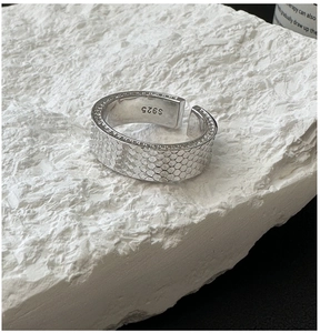 Detailed macro view of S925 sterling silver ring featuring unique honeycomb textured finish