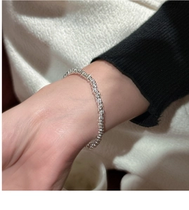 Detailed close-up of S925 sterling silver beaded bracelet with fine textured metallic finish