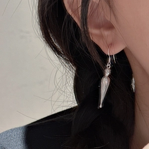 Minimalist S925 sterling silver waterdrop earrings worn by a model in a natural setting