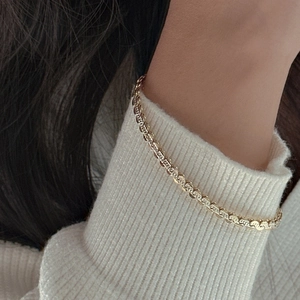 Sparkling gold S925 sterling silver gourd chain bracelet styled on wrist with sweater