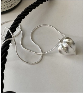 Detail of matte S925 silver physalis fruit pendant on minimalist snake chain