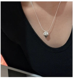 Detail of S925 sterling silver fruit-shaped pendant on a minimalist necklace for women