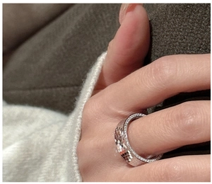 Detail of S925 sterling silver honeycomb ring with sparkling zircons on a wide band