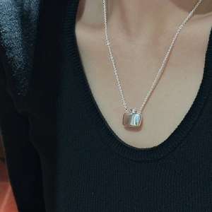 Minimalist S925 sterling silver flask pendant necklace worn on black knitwear