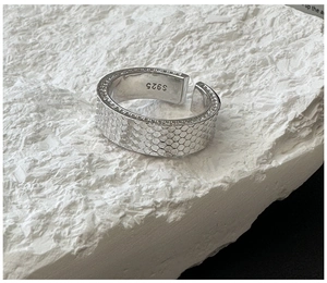 Macro detail of S925 sterling silver ring featuring a unique honeycomb scale texture