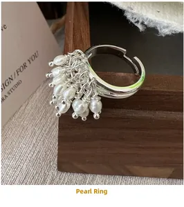 Detail of S925 sterling silver beaded ring with dangling pearls and adjustable band