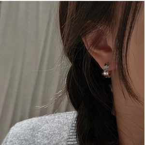 Macro view of S925 sterling silver hoop earrings with irregular hammered ice texture