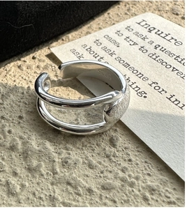 Detail of S925 sterling silver open ring featuring a brushed oval textured finish
