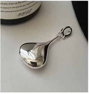 Close-up of a 3D hollow teardrop pendant in S925 sterling silver with a mirror-polished finish
