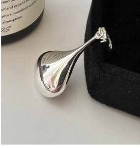 Macro detail of S925 sterling silver waterdrop pendant with polished mirror finish