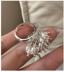 Macro shot of S925 sterling silver ring showing flexible size and dangling pearl cluster