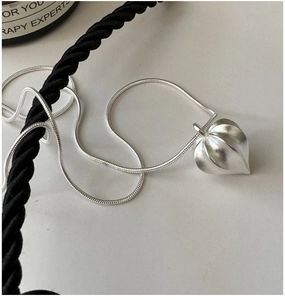Detailed view of matte S925 sterling silver geometric pendant on sleek snake chain