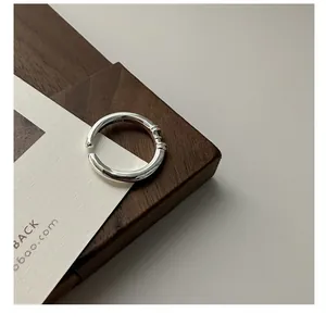 Detailed close-up of S925 sterling silver minimalist open ring with linear engravings