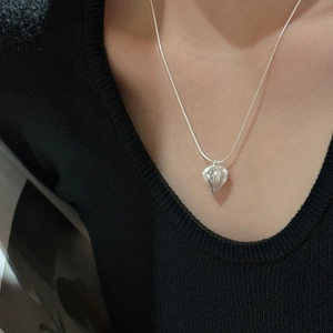 S925 sterling silver necklace with textured water-drop pendant on model against black top