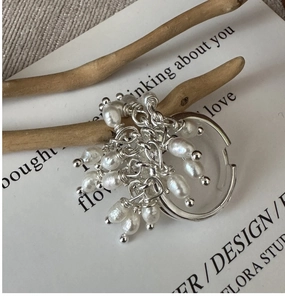 Detailed macro shot of S925 sterling silver ring with natural freshwater pearl tassels