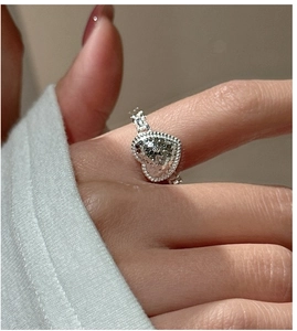 Detail of S925 sterling silver heart ring with hammer texture and chain-style band