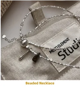 Macro shot of S925 sterling silver beaded necklace with brown stone and S925 tag