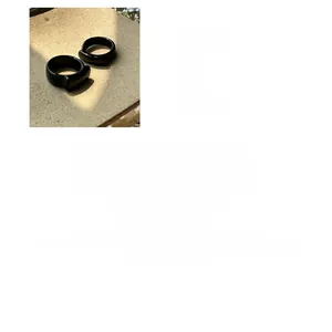 Macro detail of minimalist 925 sterling silver rings with polished black agate inlay