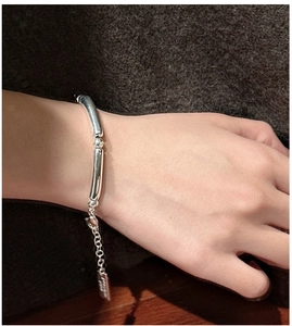 Detailed shot of S925 silver bamboo link bracelet with adjustable chain on wrist