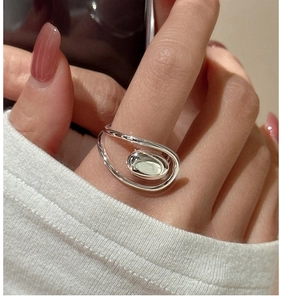 Close-up of a minimalist S925 sterling silver oval ring with a sleek wrap-around design