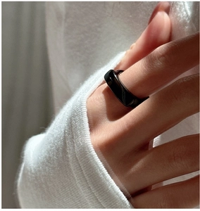 Close-up of minimalist black onyx style geometric ring on a model's finger