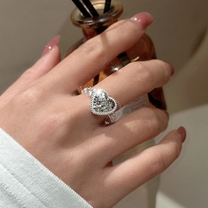 Elegant S925 sterling silver heart ring with sparkling pavé zircons on a model's finger