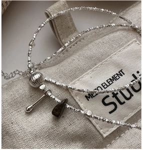Detail of S925 silver irregular beads with vintage brown stone and pumpkin charm