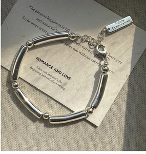 Close-up of polished S925 silver bracelet with 'Future Expectation' engraved tag